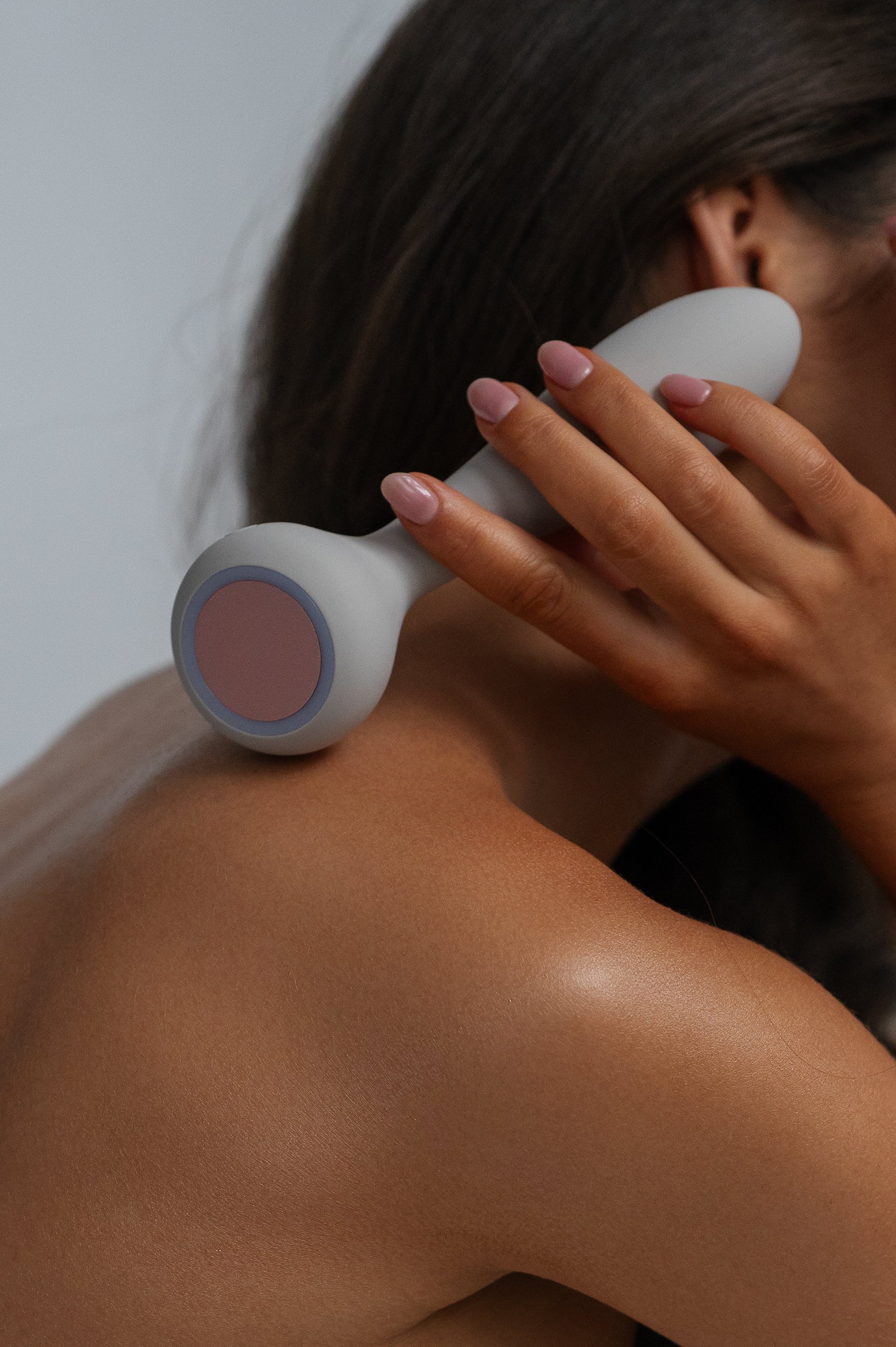 Sol - Naago. Dual-ended vibrator with heated tip held near skin, designed for external stimulation and warming foreplay