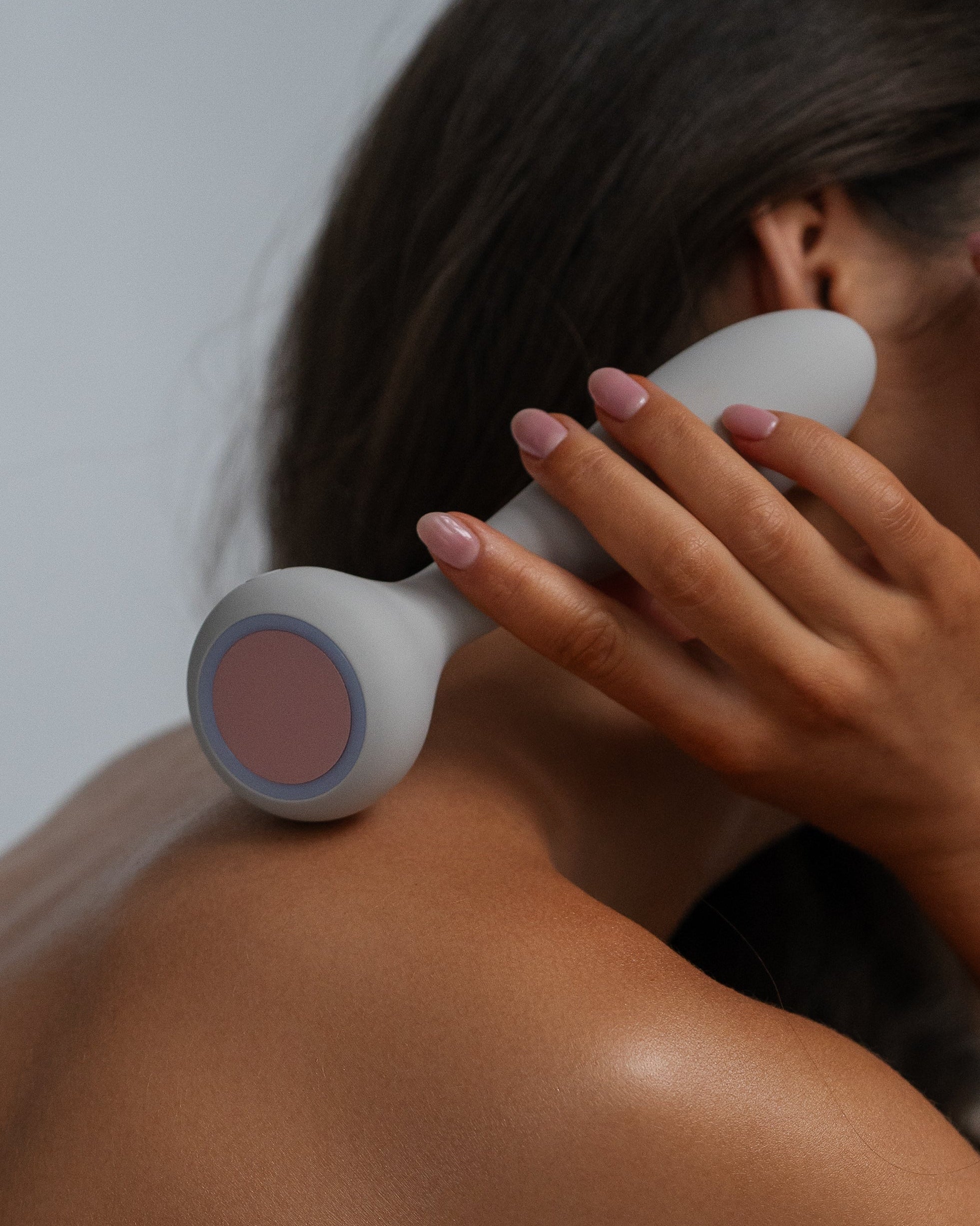 Sol - Naago. Dual-ended vibrator with heated tip held near skin, designed for external stimulation and warming foreplay